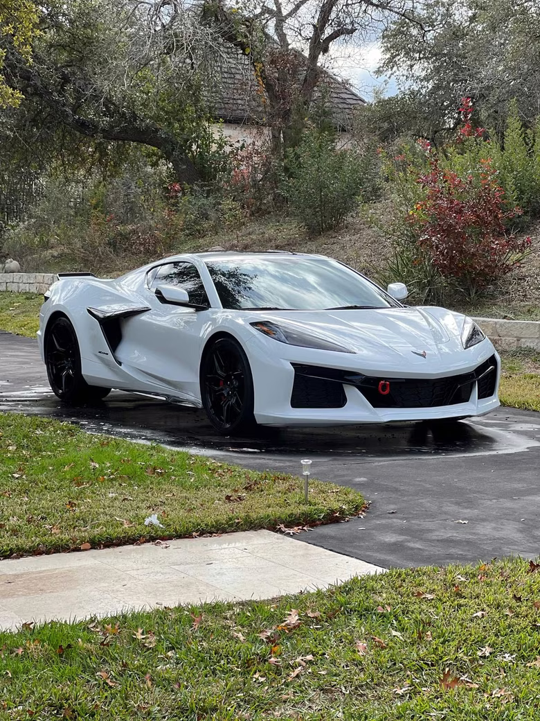 White Chevrolet Corvette Z06 freshly washed and drying in a hillside driveway