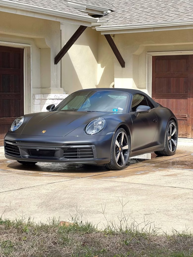 Matte black Porsche 911 Cabriolet detailed by FujiWash™ in a residential driveway